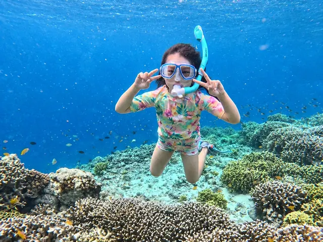 Young girl snorkelling above the coral garden at Menjangan